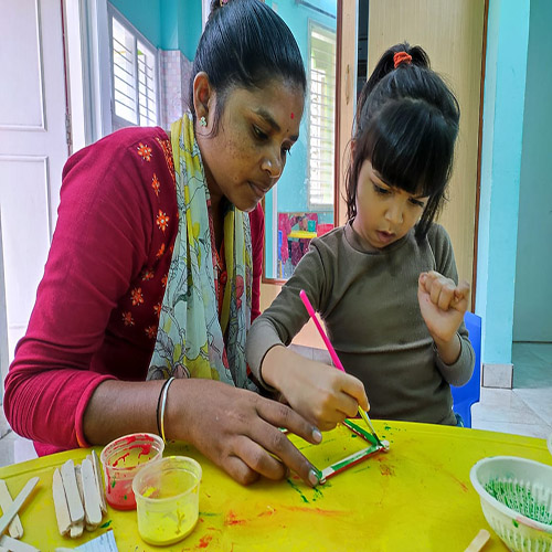 the clinician and the child are painting with colours